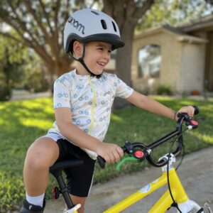Happy kid riding Woom bike with Bike & Grow handmade jersey and grey Woom helmet